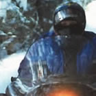 person riding a snowmobile on a trail