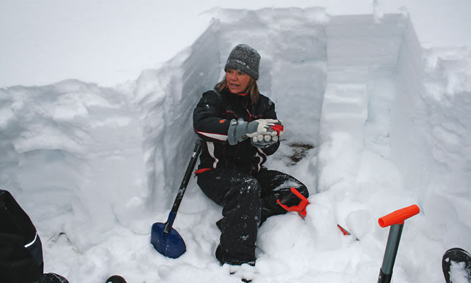 Lori Zacaruk discusses snowpack conditions during one of her avalanche safety courses. photo courtesy Lori Zacaruk