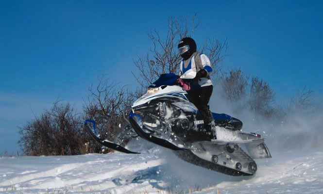 Jolene Kindiak gets airborne with her Yamaha Nytro near Yorkton. photo courtesy Jolene Kindiak