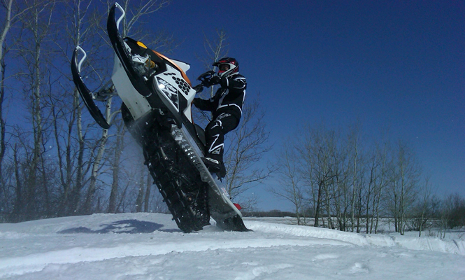 man doing a wheelie with his sled