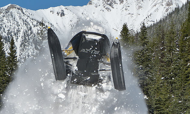 person snowmobiling in the mountains of BC