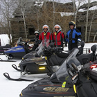 people on snowmobiles