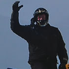 man on a sled waving