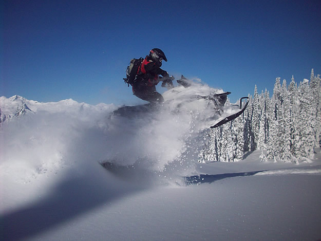 Photo of a snowmobile taking a jump