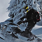 person riding a sled through powder