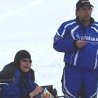 people on snowmobiles taking a break