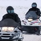 sledders waving to the camera