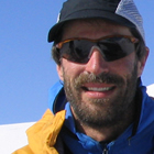 Man standing in a snowy area in the mountains